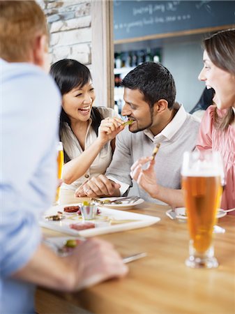 simsearch:600-03230246,k - Group of Friends Enjoying Drinks and Appetizers at Wine Bar, Toronto, Ontario, Canada Stock Photo - Premium Royalty-Free, Code: 600-03230253