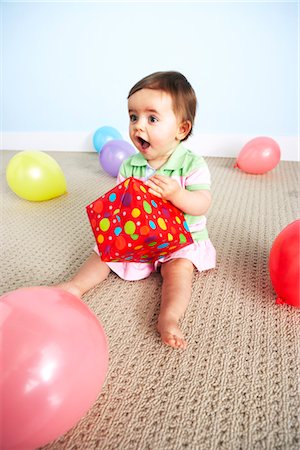 first time - Baby Girl Opening Birthday Present Stock Photo - Premium Royalty-Free, Code: 600-03265819