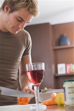 slicing vegetables - Man Chopping Vegetables in Kitchen Stock Photo - Premium Royalty-Free, Code: 600-03333342