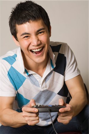 Man Playing Video Game Stock Photo - Premium Royalty-Free, Code: 600-03333382