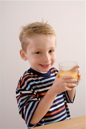 Boy Drinking Orange Juice Stock Photo - Premium Royalty-Free, Code: 600-03368371