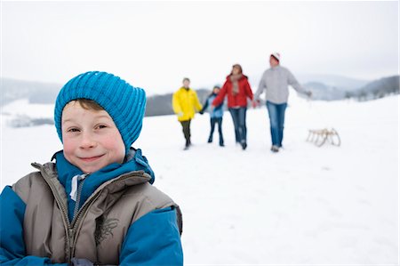 Boy Outdoors in Winter with Family Stock Photo - Premium Royalty-Free, Code: 600-03404002