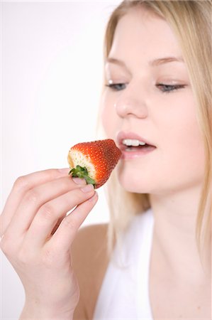 eat mouth closeup - Woman Eating Strawberry Stock Photo - Premium Royalty-Free, Code: 600-03404067