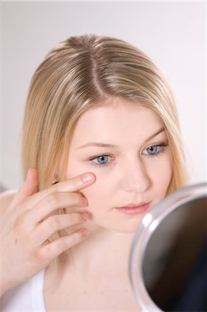 Woman Looking in Mirror Stock Photo - Premium Royalty-Free, Code: 600-03404061