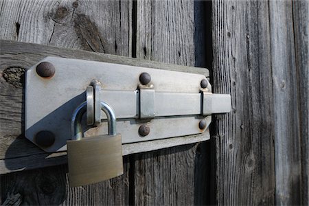 Close-up of Padlock on Wooden Door Stock Photo - Premium Royalty-Free, Code: 600-03404395