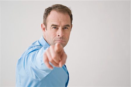 stern boss looking at camera - Businessman Pointing Stock Photo - Premium Royalty-Free, Code: 600-03404590
