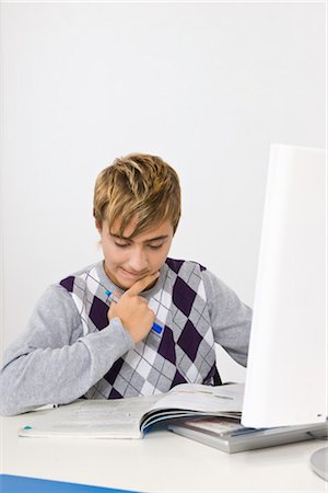 Teenage Boy Doing Homework Stock Photo - Premium Royalty-Free, Code: 600-03403988