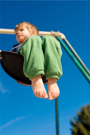 Boy on Swing, Hernando beach, Florida, USA Stock Photo - Premium Royalty-Free, Code: 600-03439259