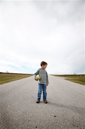 Boy Standing on Road Stock Photo - Premium Royalty-Free, Code: 600-03448805