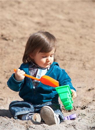 Little Boy Playing in Sand Stock Photo - Premium Royalty-Free, Code: 600-03456232