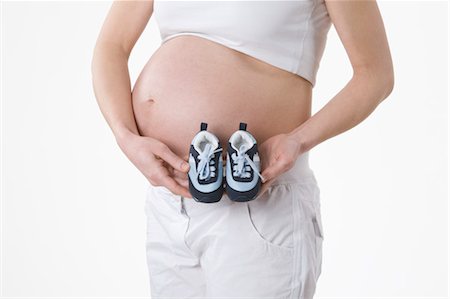 expansion (accroissement de volume) - Enceinte femme Holding Baby Shoes Photographie de stock - Premium Libres de Droits, Code: 600-03451334