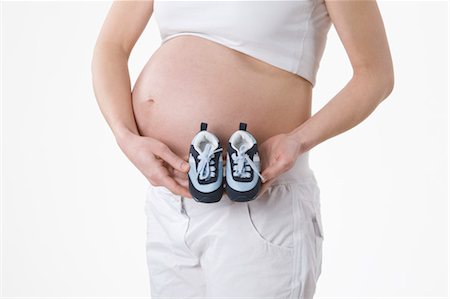 simsearch:600-03451343,k - Pregnant Woman Holding Baby Shoes Stock Photo - Premium Royalty-Free, Code: 600-03451334