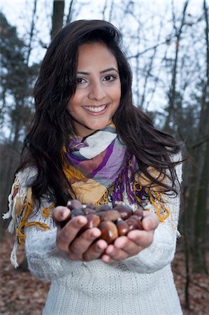 Woman With a Handful of Chestnuts Stock Photo - Premium Royalty-Free, Code: 600-03451503