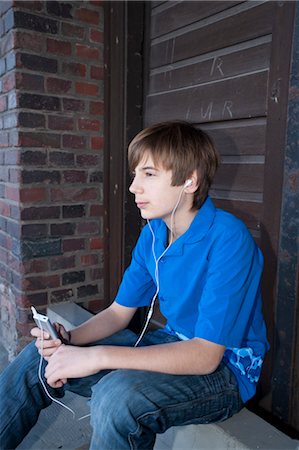 pictures of 13 year old brunette boys - Boy Listening to MP3 Player Stock Photo - Premium Royalty-Free, Code: 600-03463144