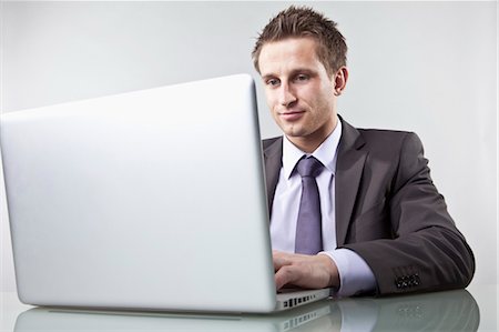 Businessman Using Laptop Computer Stock Photo - Premium Royalty-Free, Code: 600-03520284