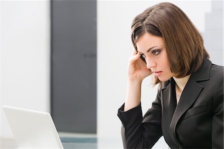 fed up office worker - Businesswoman Using Laptop Computer Stock Photo - Premium Royalty-Free, Code: 600-03520605