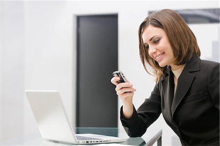 phone young woman computer - Businesswoman Reading Text Message Stock Photo - Premium Royalty-Free, Code: 600-03520606