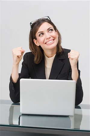 simsearch:700-06368091,k - Excited Businesswoman Using Laptop Computer Fotografie stock - Premium Royalty-Free, Codice: 600-03520608