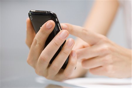 Close-up of Businesswoman Dialing Cell Phone Stock Photo - Premium Royalty-Free, Code: 600-03520625