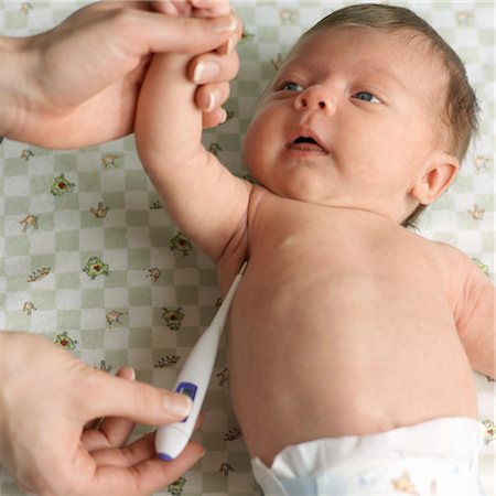 parents with sick baby - Woman Taking Baby's Temperature with Digital Thermometer Stock Photo - Premium Royalty-Free, Code: 600-03587152