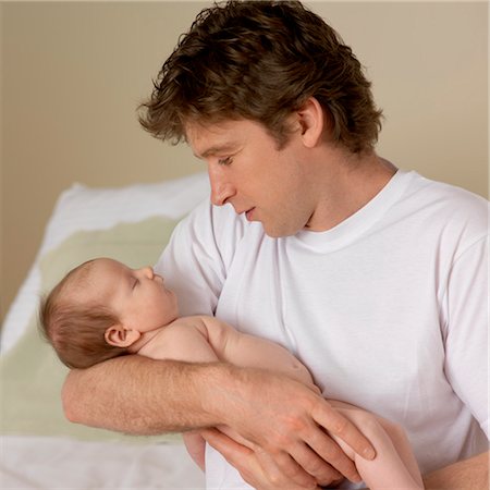 Sleeping Baby Held by Father Stock Photo - Premium Royalty-Free, Code: 600-03615823