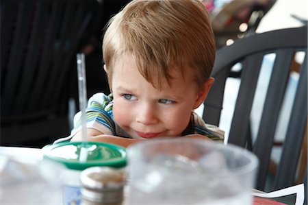 Boy Sitting at Table, Houston, Texas, USA Stock Photo - Premium Royalty-Free, Code: 600-03616044