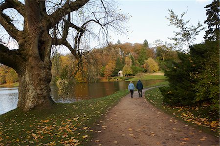 Couple Walking on Path by Pond, Stourhead, Wiltshire, England Stock Photo - Premium Royalty-Free, Code: 600-03686050