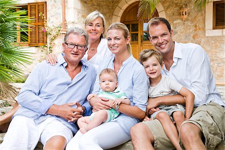 family portraits outside home - Portrait of Family in Front of Home Stock Photo - Premium Royalty-Free, Code: 600-03682272