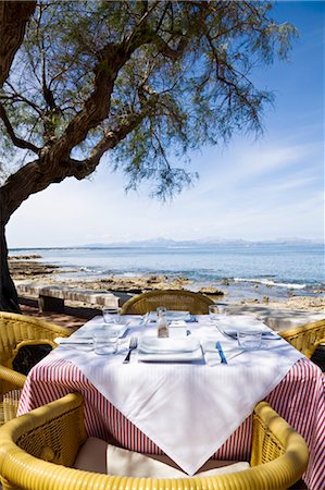 Restaurant Table Overlooking the Beach, Majorca, Spain Stock Photo - Premium Royalty-Free, Code: 600-03682283