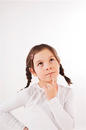 finger white background - Portrait of Girl Thinking Stock Photo - Premium Royalty-Free, Code: 600-03697811