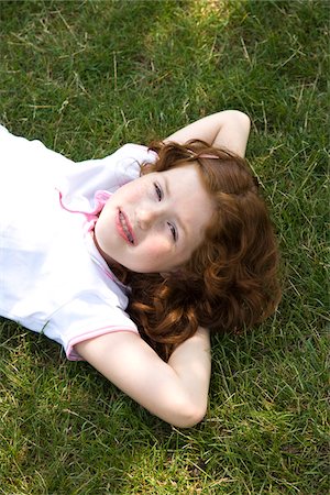 preteen girl redhead - Little Girl Lying on the Grass Stock Photo - Premium Royalty-Free, Code: 600-03692097