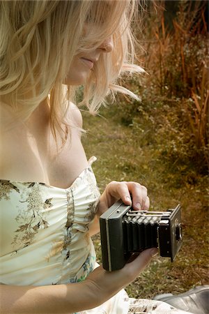 Woman Holding Folding Camera, High Park, Toronto, Ontario, Canada Stock Photo - Premium Royalty-Free, Code: 600-03715415