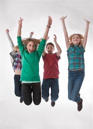 preteen boy happy white background - Adolescents sautant en l'Air Photographie de stock - Premium Libres de Droits, Code: 600-03734623