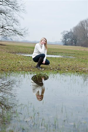 reflection in puddle - Young Woman Stock Photo - Premium Royalty-Free, Code: 600-03739303