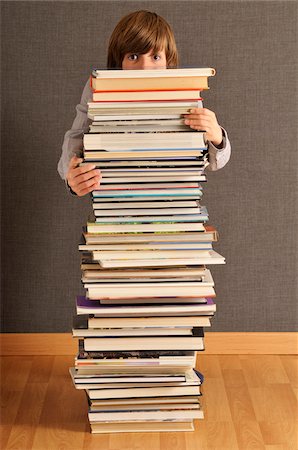 Boy Behind Stack of Books Stock Photo - Premium Royalty-Free, Code: 600-03768646