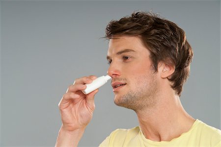 Man Using Nasal Spray Stock Photo - Premium Royalty-Free, Code: 600-03787518