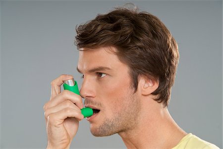 spraying - Man Using Inhaler Stock Photo - Premium Royalty-Free, Code: 600-03787513