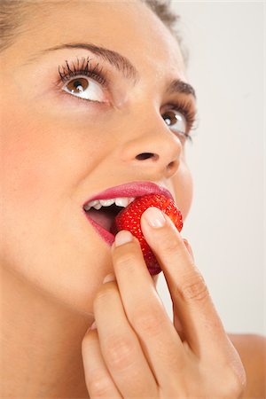 simsearch:600-03787546,k - Woman Eating Strawberry Stock Photo - Premium Royalty-Free, Code: 600-03787562