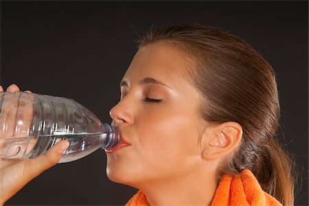 side profile portrait eyes closed studio - Young Woman Drinking Water Stock Photo - Premium Royalty-Free, Code: 600-03799524