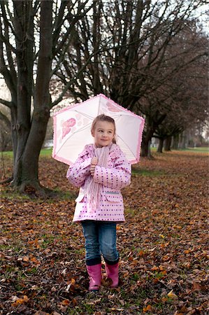 person and raincoat and umbrella - Girl with Umbrella Outdoors Stock Photo - Premium Royalty-Free, Code: 600-03814438