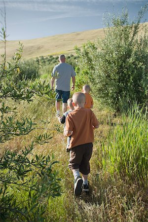 father son walking in field - Father and Sons Walking, Livermore, Alameda County, California, USA Stock Photo - Premium Royalty-Free, Code: 600-03814642