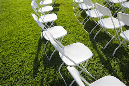 folded chairs on the grass - White Chairs Outdoors Stock Photo - Premium Royalty-Free, Code: 600-03814721