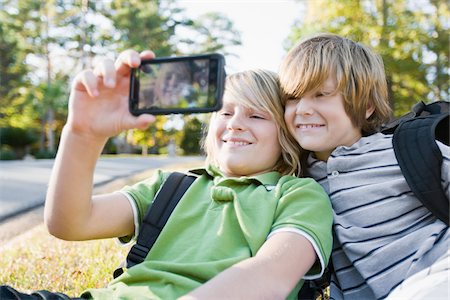 Boys taking Picture with Camera Phone Stock Photo - Premium Royalty-Free, Code: 600-03848739