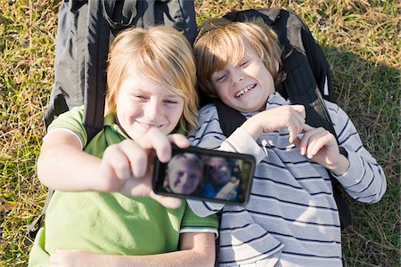 preteen selfie - Boys taking Picture with Camera Phone Stock Photo - Premium Royalty-Free, Code: 600-03848740