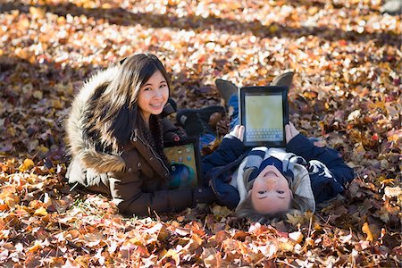 Girls using iPads in Autumn Stock Photo - Premium Royalty-Free, Code: 600-03848750