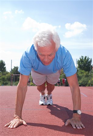 senior man exercising - Man Exercising Outdoors on Track Stock Photo - Premium Royalty-Free, Code: 600-03848777