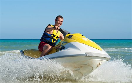 Man on Personal Watercraft Stock Photo - Premium Royalty-Free, Code: 600-03849568