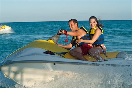 Couple on Personal Watercraft Stock Photo - Premium Royalty-Free, Code: 600-03849571