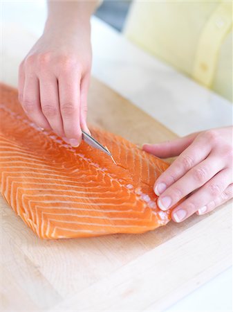 fish and meat - Woman using Tweezers to Remove Bones from Salmon Stock Photo - Premium Royalty-Free, Code: 600-03849754