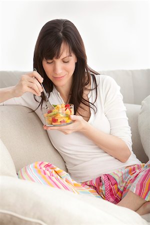 eating sofa - Woman Eating Fruit Salad Stock Photo - Premium Royalty-Free, Code: 600-03891309